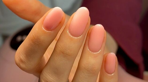 Primo piano di una manicure BIAB rosa trasparente